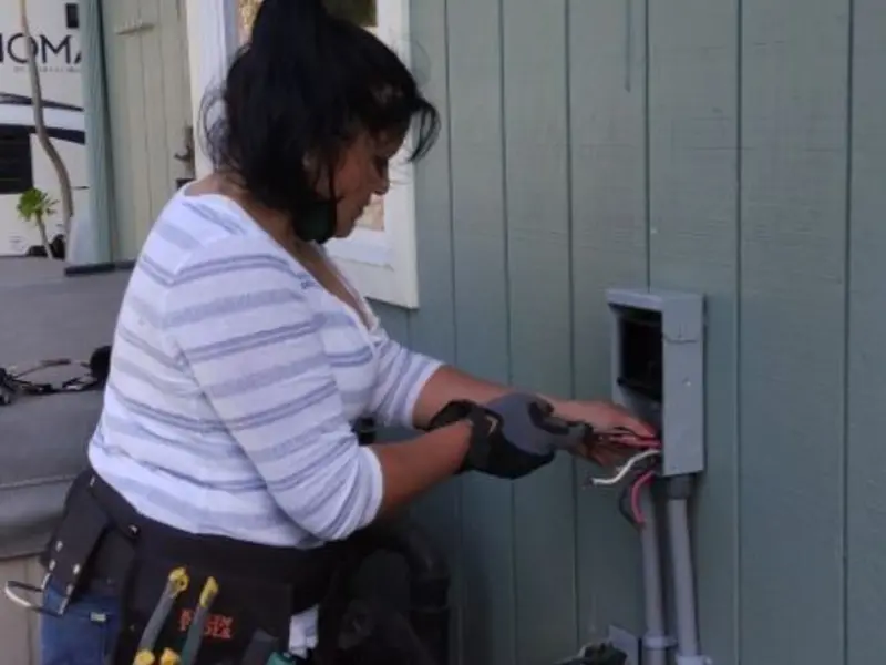 Licensed electrician wiring an exterior subpanel in Sterling Ranch