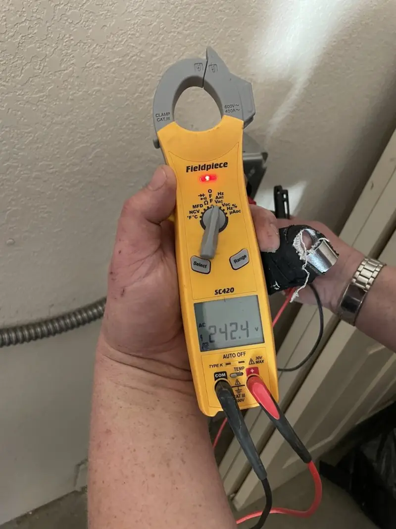 Voltage testing with clamp meter during Generator Installation in Sterling Ranch